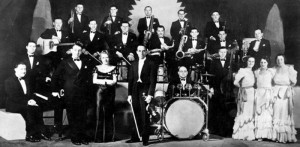 Ambrose and His Orchestra in 1935. Ambrose is at the center, with Elsie Carlisle and Sam Browne to the left and the Rhythm Sisters to the right.