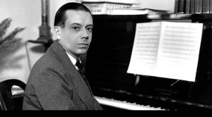 "Let's Do It" featured image. Photograph of Cole Porter at the piano.