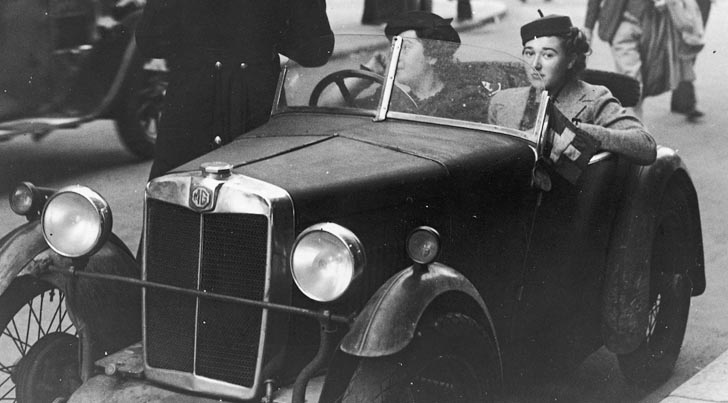 "Waiting for the Lights to Change" featured image. 1930s London motorists receiving a traffic ticket.