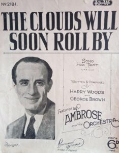 "The Clouds Will Soon Roll By." Sheet music featuring Ambrose's face.