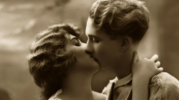 Young man kissing young woman